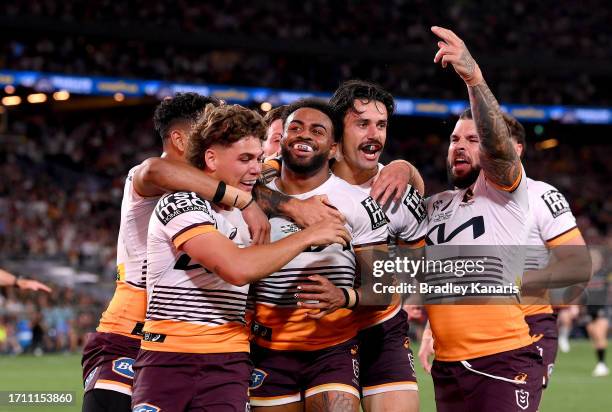 Ezra Mam of the Broncos is congratulated by team mates after scoring a try during the 2023 NRL Grand Final match between Penrith Panthers and...