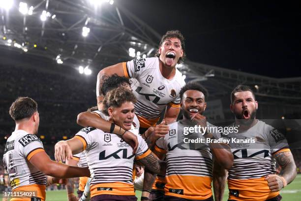 Ezra Mam of the Broncos is congratulated by team mates after scoring a try during the 2023 NRL Grand Final match between Penrith Panthers and...