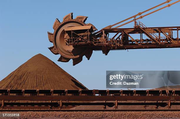 iron ore reclaimer machine and stockpile  - mining machinery stock pictures, royalty-free photos & images