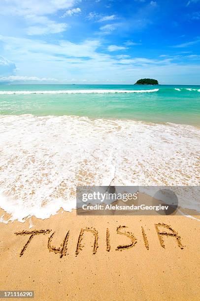 tunisia written on the sand - tunisia beach stock pictures, royalty-free photos & images