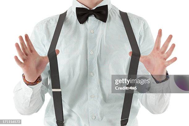 midsection view of a man pulling suspenders - suspenders 個照片及圖片檔