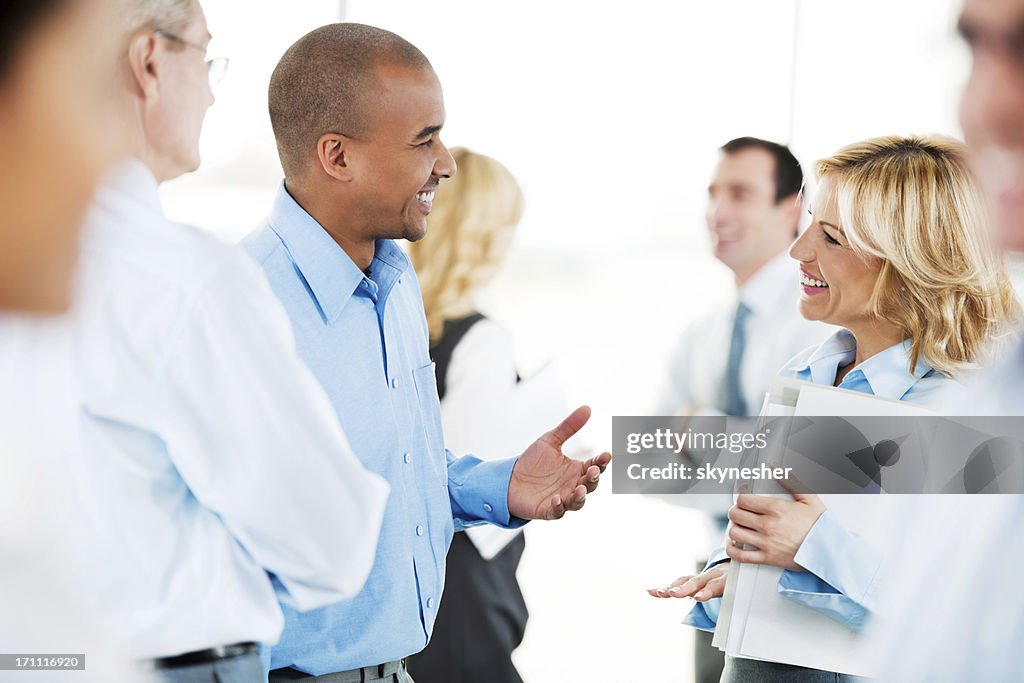Group of successful businesspeople standing and talking.