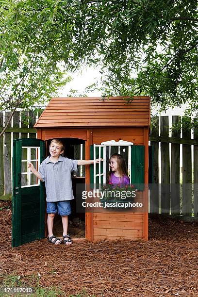 kids having fun with playhouse - playhouse stockfoto's en -beelden