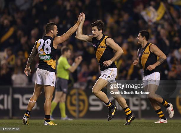 Trent Cotchin of the Tigers celebrates after kicking a goal during the round 13 AFL match between the Western Bulldogs and the Richmond Tigers at...