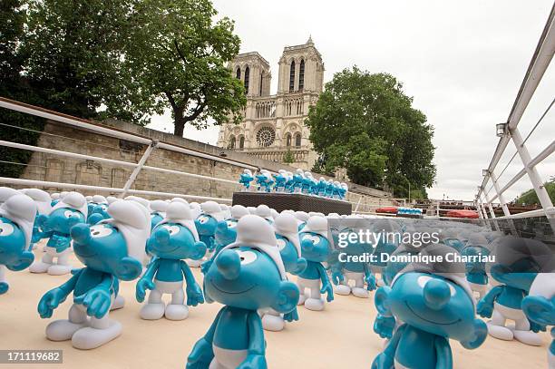 Smurf figurines pass Notre Dame as they travel down the River Seine to mark Global Smurfs Day on June 22, 2013 in Paris, France.