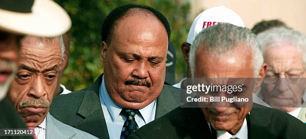 Rev. Al Sharpton and Martin Luther KIng III , son of the slain civil rights leader Martin Luther King, bow their heads during a prayer at a press...