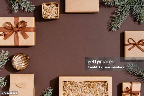 brown gift boxes with gift tag decorations and christmas tree branch - boxing day stock pictures, royalty-free photos & images