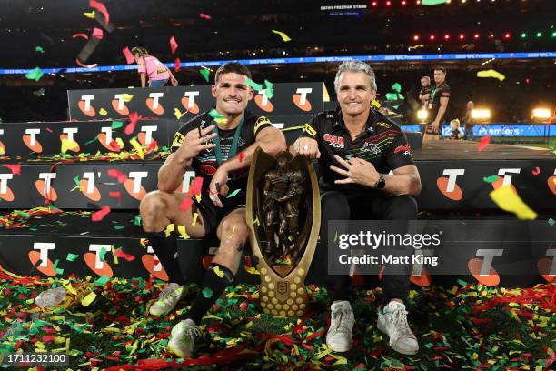 Nathan Cleary of the Panthers pose with the Provan-Summons Trophy with his father and coach Ivan Cleary after winning the 2023 NRL Grand Final match...
