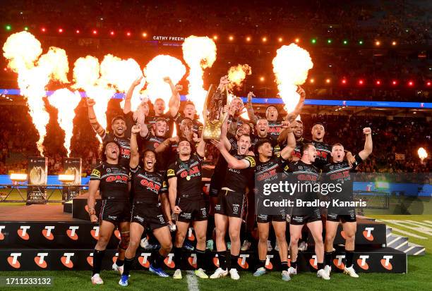 The Panthers players celebrate victory as the hold up the premiership trophy after the 2023 NRL Grand Final match between Penrith Panthers and...