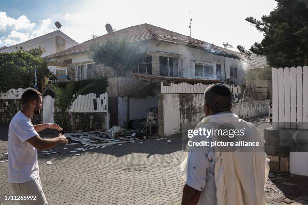 October 2023, Israel, Ashkelon: Residents inspect damage caused by a rocket attack from Gaza. Palestinian militants in Gaza unexpectedly fired dozens...