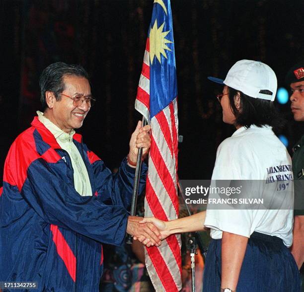 Malaysian Prime Minister Mahathir Mohamad receives the national flag during the 40th National day celebration at Merdeka Square in Kuala Lumpur 31...