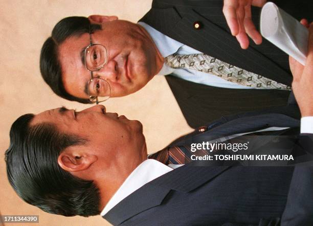 Japanese Prime Minister and ruling Liberal Democratic Party President Ryutaro Hashimoto speaks to LDP secretary general Koichi Kato after a press...