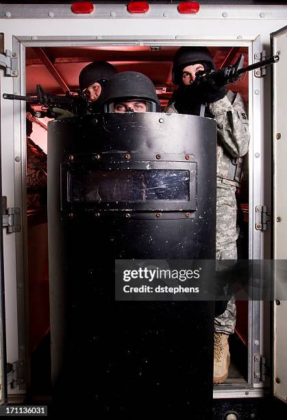 swat team exiting - blocking door stock pictures, royalty-free photos & images