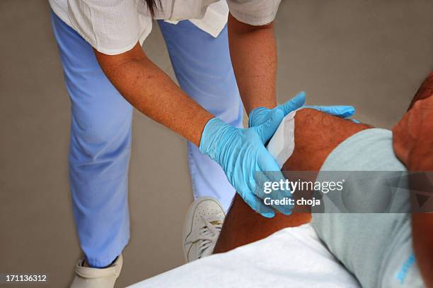 nurse is taking care of the wounded knee,changing bandage - bandage stock pictures, royalty-free photos & images