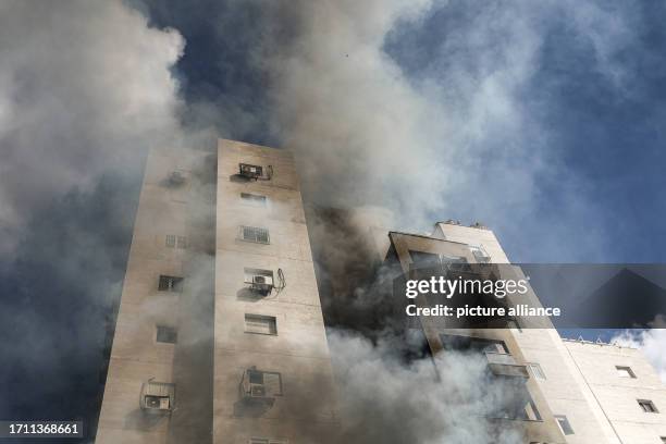 October 2023, Israel, Ashkelon: Smoke can be seen coming from a residential building following rocket attack from Gaza. Palestinian militants in Gaza...