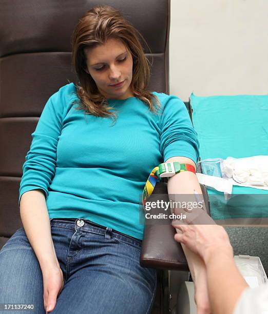 young woman donating blood in a blood bank - hiv test 個照片及圖片檔