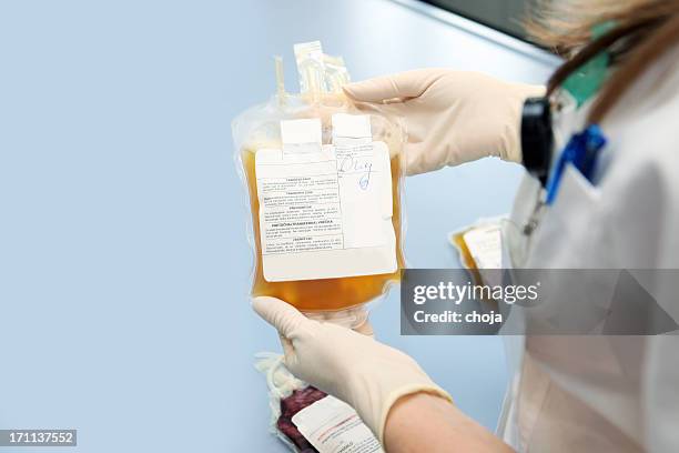 doctor in a blood bank holding  bag  with white cells - plasma stockfoto's en -beelden