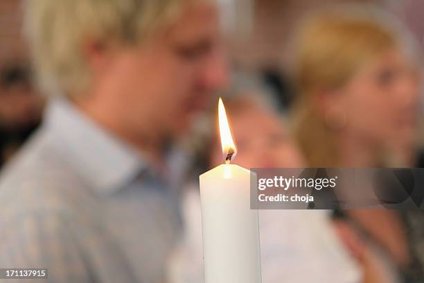 young parents with their baby waiting to be baptized. - sacrament stock pictures, royalty-free photos & images