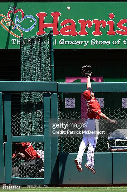 Stephen Lombardozzi of the Washington Nationals is unable to catch a solo home run hit by DJ LeMahieu of the Colorado Rockies in the first inning...