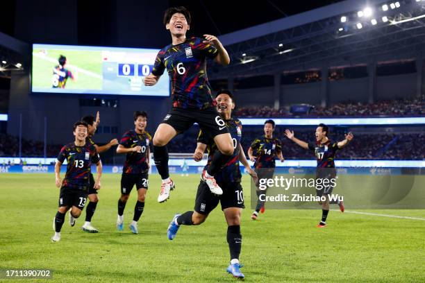 Hong Hyunseok of South Korea celebrates his goal with teammates during the 19th Asian Game Men's Quarterfinal between China and South Korea at...