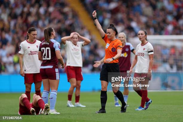Referee, Rebecca Welch, shows a red card to Kirsty Hanson of Aston Villa during the Barclays Women's Super League match between Aston Villa and...
