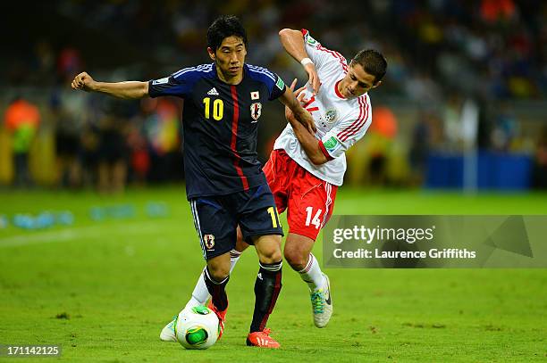 Shinji Kagawa of Japan fights for the ball against Javier Hernandez of Mexico during the FIFA Confederations Cup Brazil 2013 Group A match between...