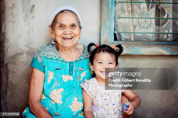 asian girl and her great grandmother - philippines family stock pictures, royalty-free photos & images