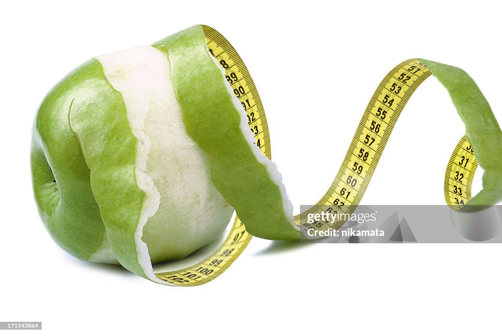 Apple peeled with twisting skin as measuring tape