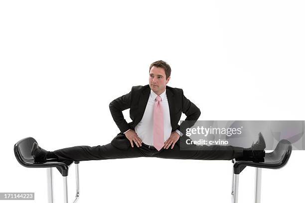 manager is caught between two chairs - split acrobatiek stockfoto's en -beelden