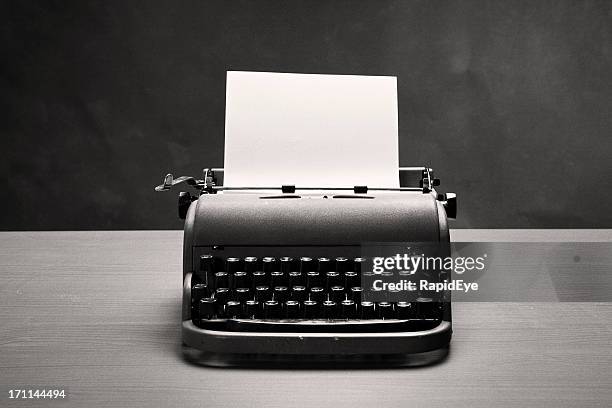 moody film noir shot of vintage typewriter and blank paper - old typewriter stock pictures, royalty-free photos & images