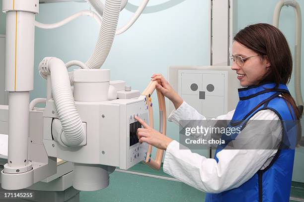 young radiologist working with modern x-ray machine - protection stockfoto's en -beelden