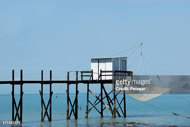 fishing cabin and carrelet net near la rochelle - seascape stock pictures, royalty-free photos & images