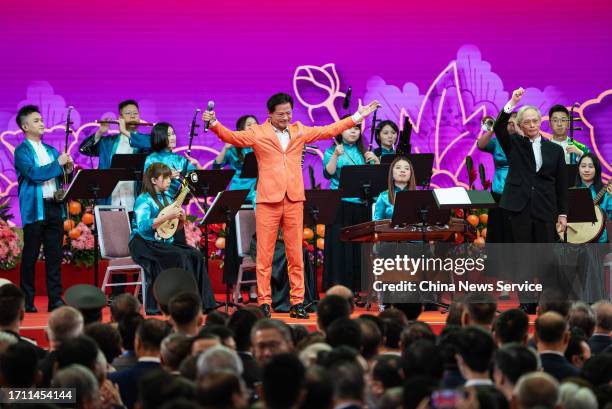 Singer Warren Mok Wah-yeun performs at a reception in celebration of the 74th anniversary of the founding of the People's Republic of China at the...