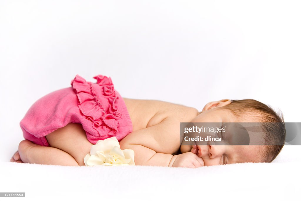 Sleeping newborn baby girl with white rose