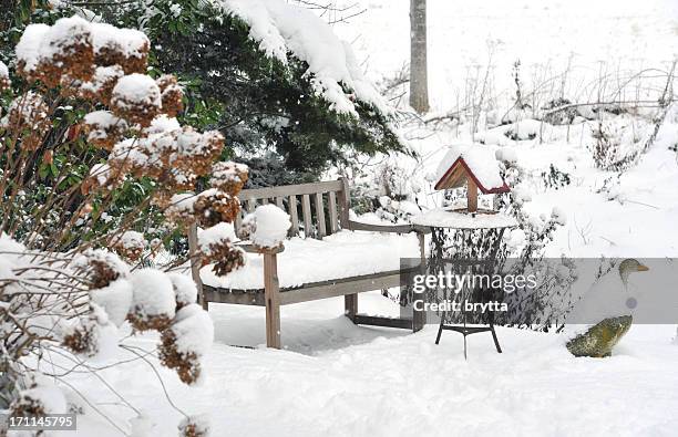 winter garden with bench, bird feeder,side table ,stone goose - formele tuin stockfoto's en -beelden