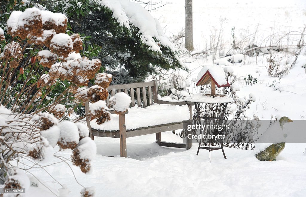 Winter garden with bench, bird feeder,side table ,stone goose