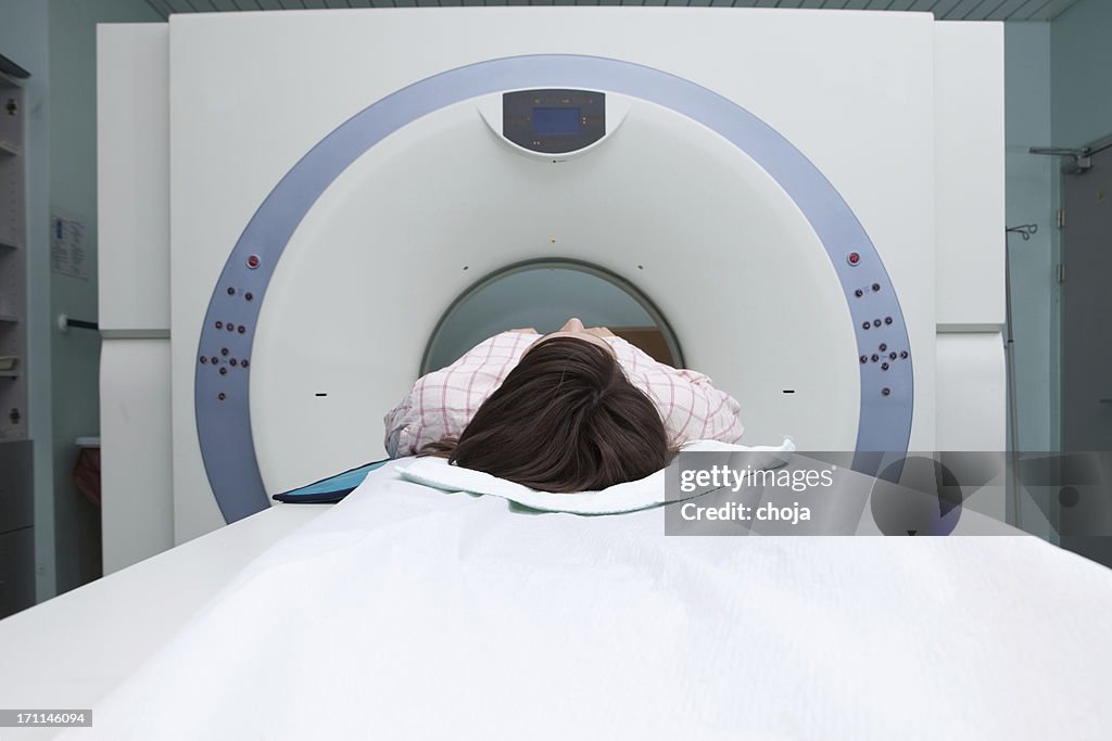 Young girl in a CAT scan machine waiting for exam