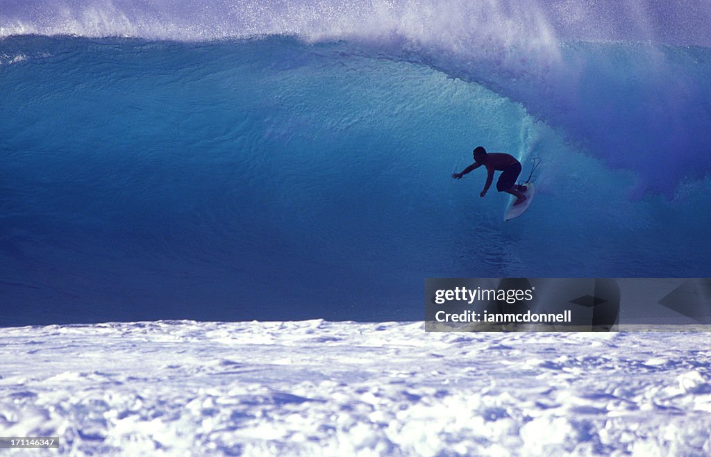 Surfer on a blue wave