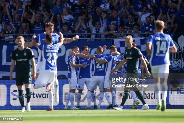 Matthias Bader of SV Darmstadt 98 celebrates with teammates after scoring the team's first goal during the Bundesliga match between SV Darmstadt 98...