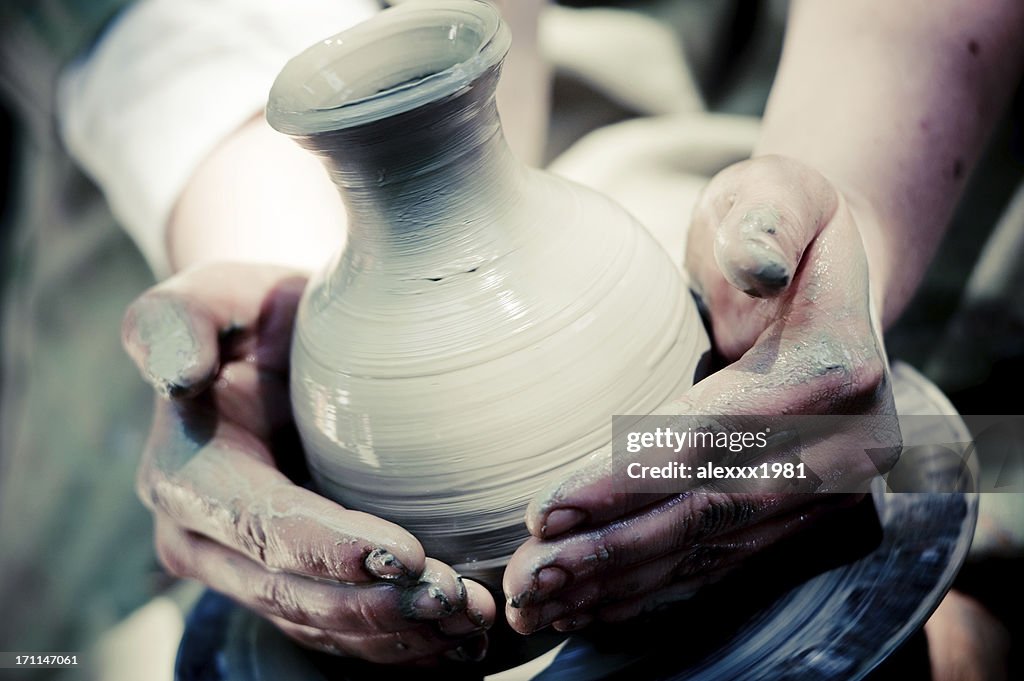 Potter makes a jug out of clay