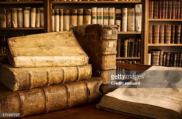vintage books in a library - ancient stock pictures, royalty-free photos & images