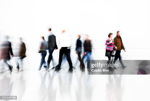 motion blurred pedestrians rushing in front of white wall - crowd of people white background stock pictures, royalty-free photos & images