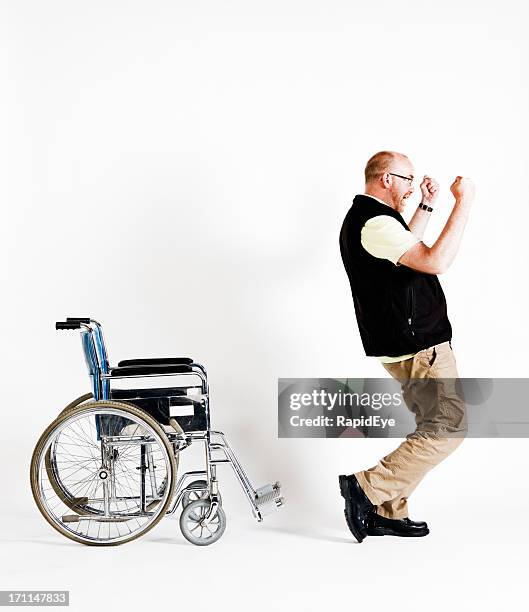 delighted man rises from wheelchair, able to walk - miracle cure stock pictures, royalty-free photos & images