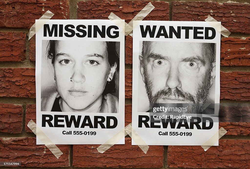 &quot;Missing&quot; and &quot;Wanted&quot; posters taped to brick wall