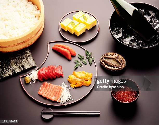 hand rolled temaki sushi set on black table - hand roll stock pictures, royalty-free photos & images