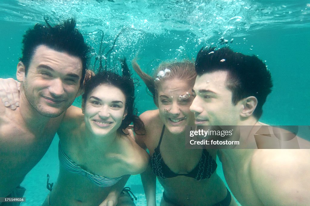 Group of friends having fun underwater