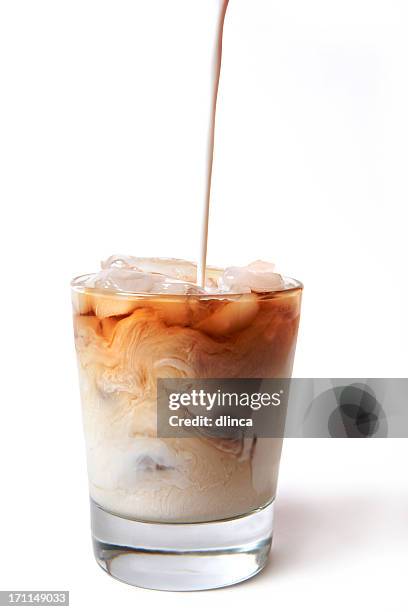 iced coffee with cream being poured in - milk swirl stock pictures, royalty-free photos & images