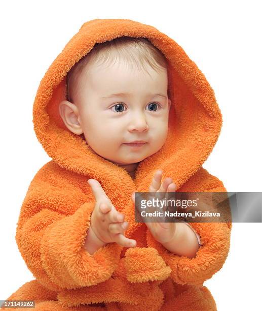 baby in orange bathrobe - clapping hands on white stock pictures, royalty-free photos & images