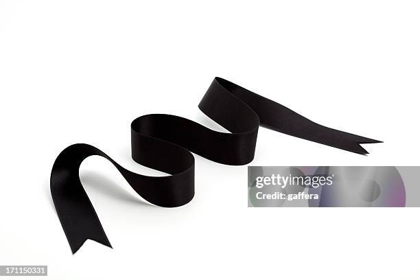 a wavy black ribbon on a white background - black satin stock pictures, royalty-free photos & images
