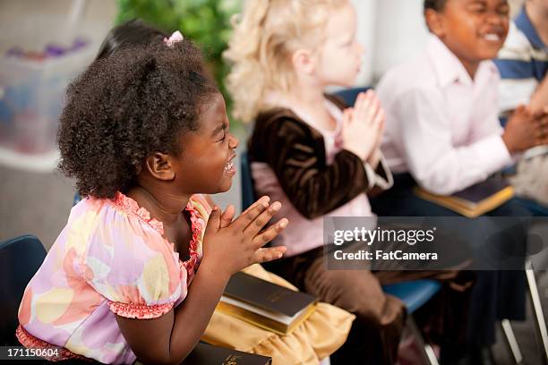 sunday school kids - child praying stock pictures, royalty-free photos & images